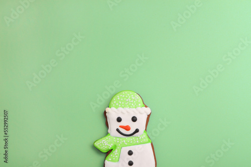 snowman gingerbread on green background. Christmas happy cookie. smiling sweet decoration