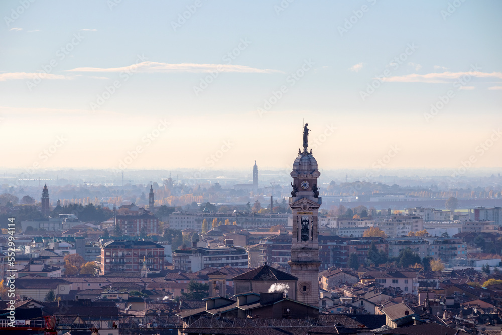Bergamo old town on top of a hill with blue sky and mountains in the background