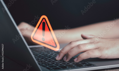 Triangle caution warning sign on laptop screen and Businessman or it staff , programmer, developer using computer for notification problem error 404 and maintenance concept.