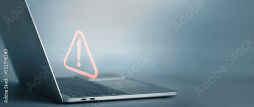 Plakat Triangle caution warning sign on laptop screen and Businessman or it staff , programmer, developer using computer for notification problem error 404 and maintenance concept.