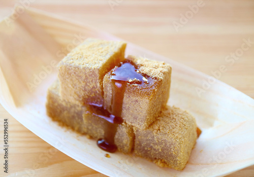 Delectable Japanese Traditional Confection Called Warabimochi Dripped with Kuromitsu Syrup photo