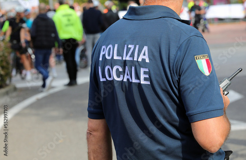 Vicenza, VI, Italy - October 9, 2022: policeman in uniform and text that means LOCAL POLICE in Italian