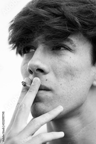 Young man smoking close-up portrait