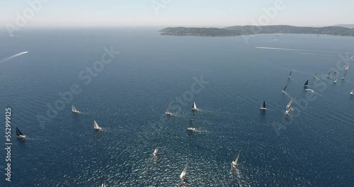 cinematic look of the start of the Rolex Giraglia 2019 regatta, many sailing yachts have started and are making maneuvers dramatic sky photo