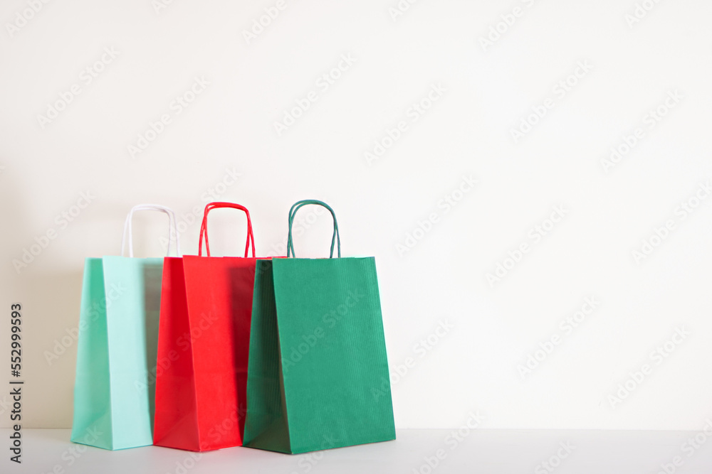 Christmas New Year colorful paper bags. Sales and shopping concept. Copy space.