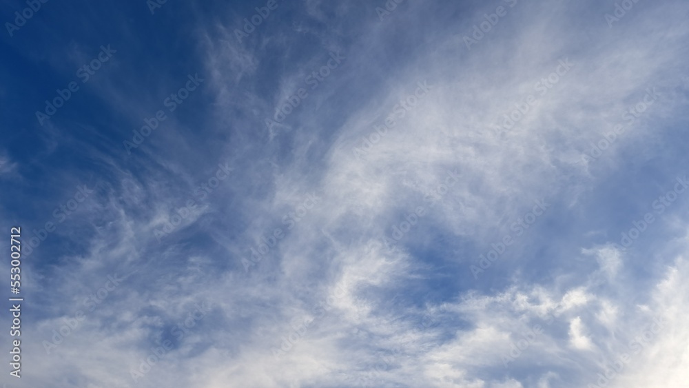 Blue sky and white streaks of clouds. Background. Texture. Copy space