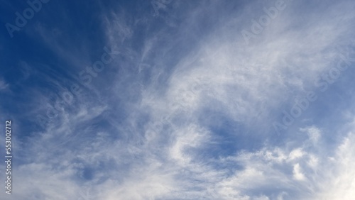 Blue sky and white streaks of clouds. Background. Texture. Copy space