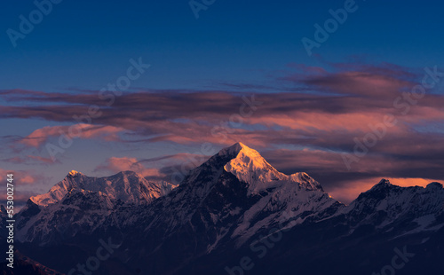 First ray of morning sun on the majestic Kangchenjunga range (third highest in the World) of Himalayas. The highlighted peak is Mt. Siniolchu (6,888 metres) in centre. Photo taken from Sandakphu, WB. © suprabhat