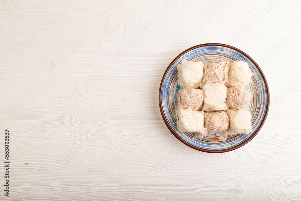 traditional arabic sweets pishmanie on white wooden, top view, copy space. traditional arabic sweets pishmanie on white wooden, top view, copy space.