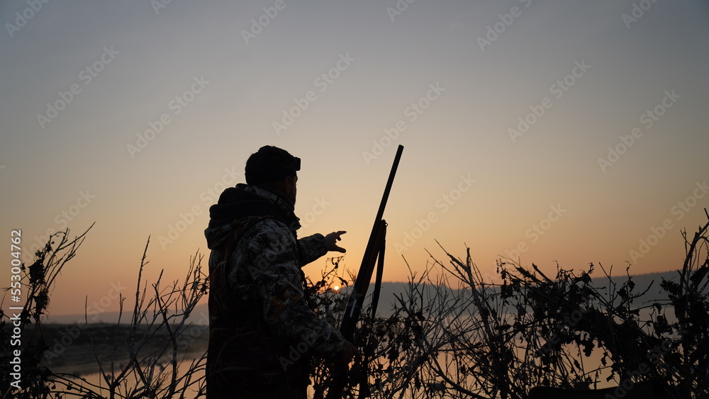 hunting by the creek in the forest. And hunting birds. Hunter hunting at sunrise hunting by the creek in the forest. And hunting birds. Hunter hunting at sunrise