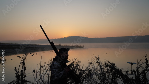 hunting by the creek in the forest. And hunting birds. Hunter hunting at sunrise