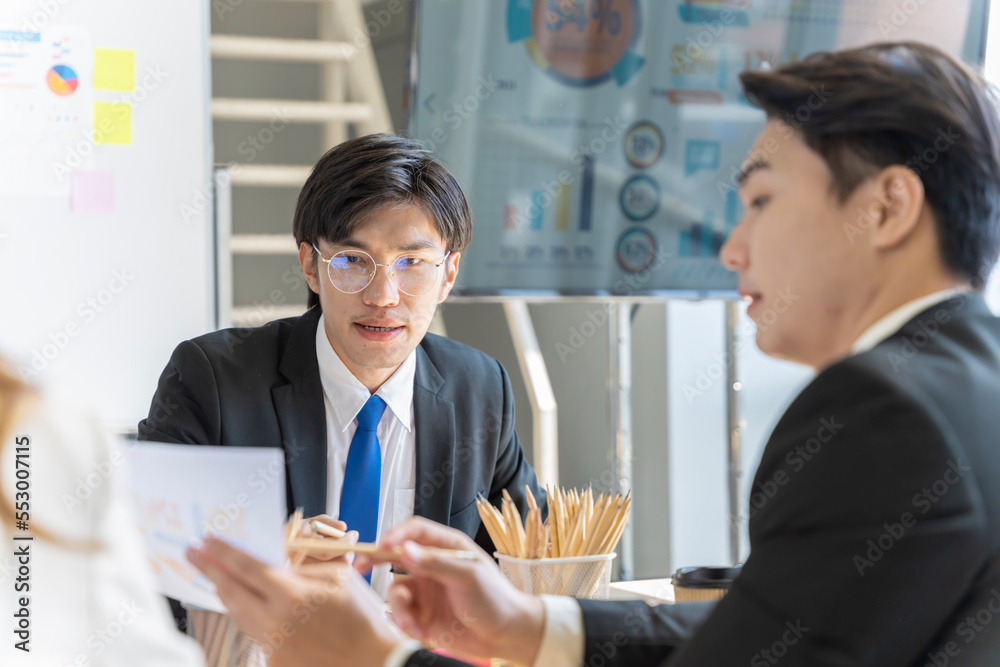 A group of young Asian businessmen Talking and planning work happily and have fun. at the company's office A group of young Asian businessmen Talking and planning work happily and have fun. at the company's office