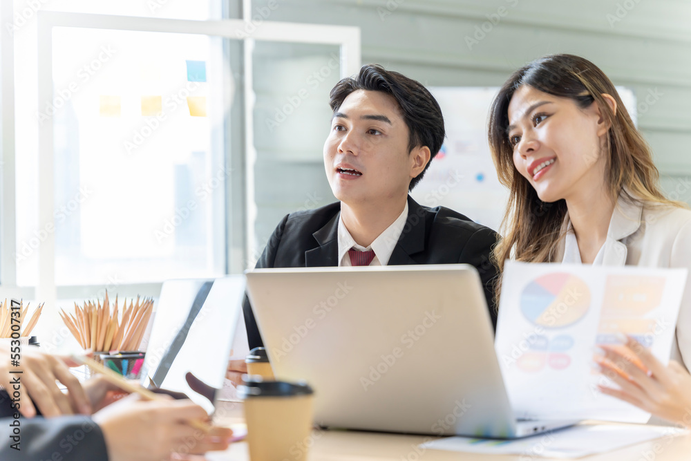 A group of young Asian businessmen Talking and planning work happily and have fun. at the company's office A group of young Asian businessmen Talking and planning work happily and have fun. at the company's office