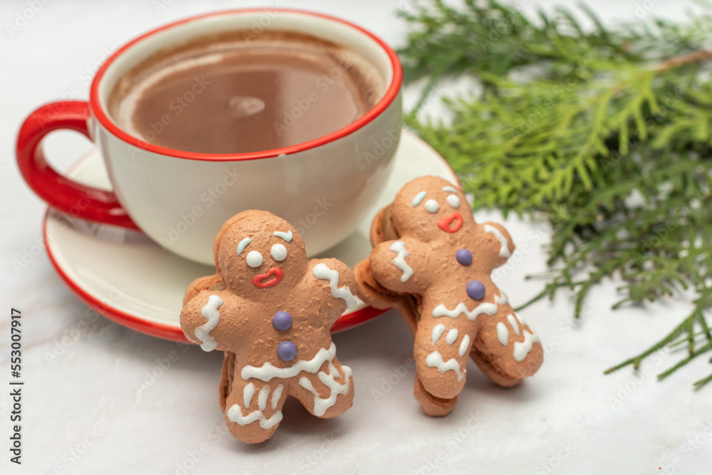 Hot winter drink - chocolate in white mug with gingerbread man. Christmas time. Cozy home atmosphere, white background. Holiday mood in the air