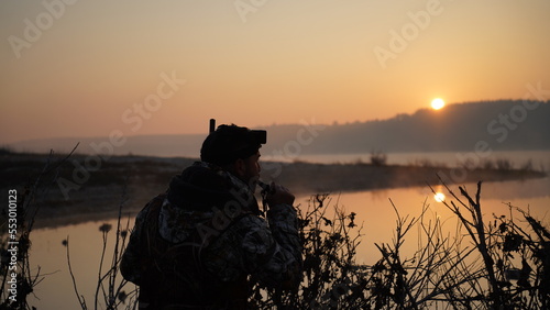 hunting by the creek in the forest. And hunting birds. Hunter hunting at sunrise