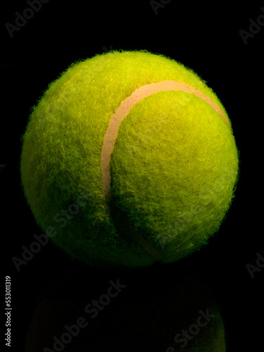 tennis ball on black background © Bill Ragan