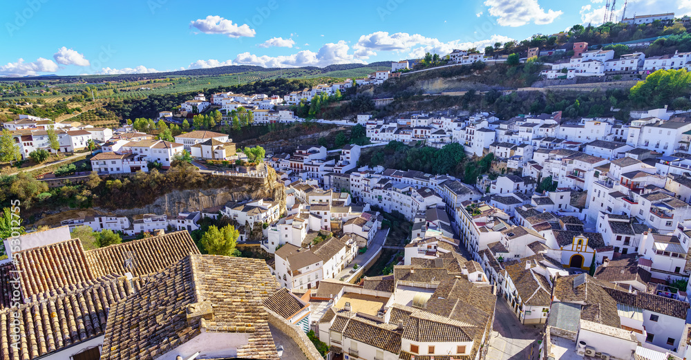 Aerial view of a beautiful Andalusian village of white houses built on the mountainside, Setenil de las Bodegas, Cadiz.
