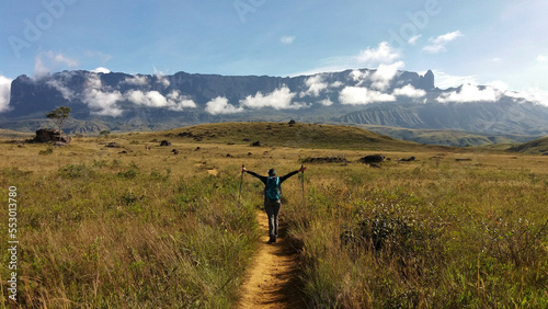 woman with backpack trekking towards mount Roraima