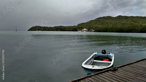 small boat moored in a bay on a cloudy day