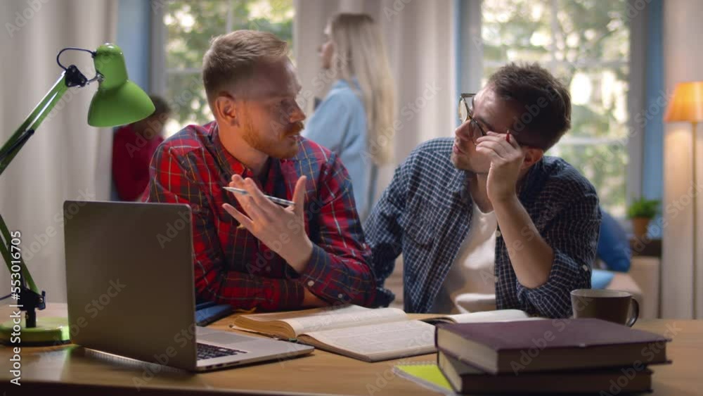 College students prepare for exam with laptop. Friends study together in dorm or library. Realtime College students prepare for exam with laptop. Friends study together in dorm or library. Realtime