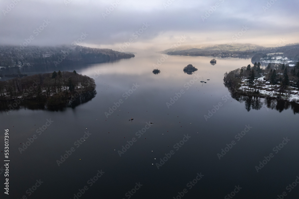 Lake Windermere, Lake District in England in winter with snow on the ground. Aerial drone above view. Lake Windermere, Lake District in England in winter with snow on the ground. Aerial drone above view.