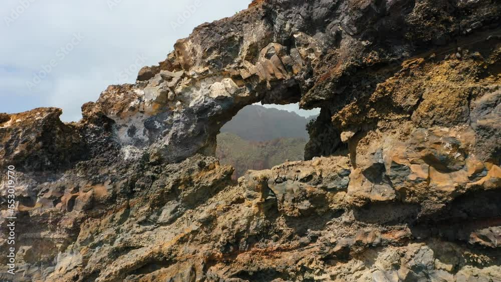 Cinematic aerial flying through rocky natural hole in coastal cliff Los Gigantes El agujero in Tenerife, Canary Islands Spain. Amazing landscape. Hiking area. Huge volcanic formation. Cinematic aerial flying through rocky natural hole in coastal cliff Los Gigantes El agujero in Tenerife, Canary Islands Spain. Amazing landscape. Hiking area. Huge volcanic formation.