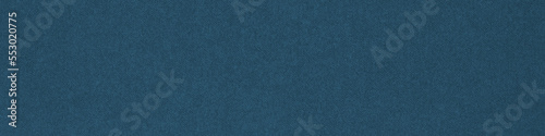 Dark blue colored paper texture. Tinted banner. Textured header. Large patterned surface. Fibers and irregularities are visible. Top-down