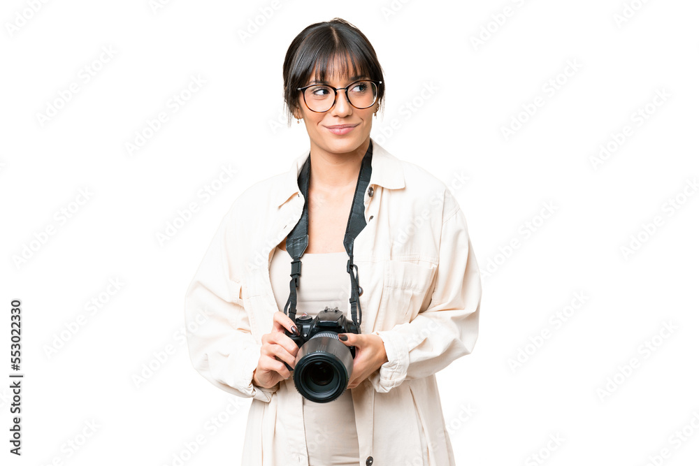 Young photographer caucasian woman over isolated chroma key background looking to the side Young photographer caucasian woman over isolated chroma key background looking to the side