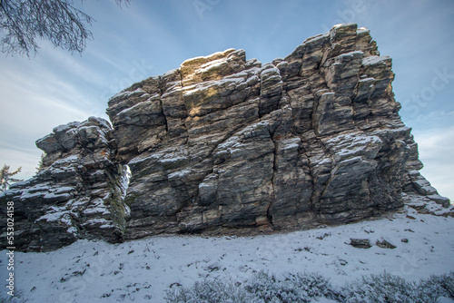 snowy rock on the background of the blue sky