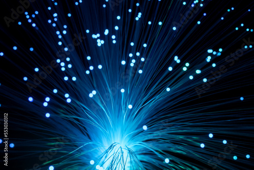 Background with blur sparkles of blue optical fibers.