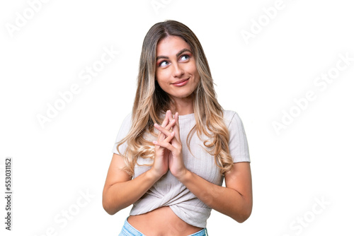 Young Uruguayan woman over isolated background scheming something