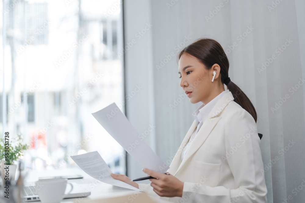 Business Professional Accountant Woman working on laptop computer making research for planning startup at desktop working process in office Business Professional Accountant Woman working on laptop computer making research for planning startup at desktop working process in office