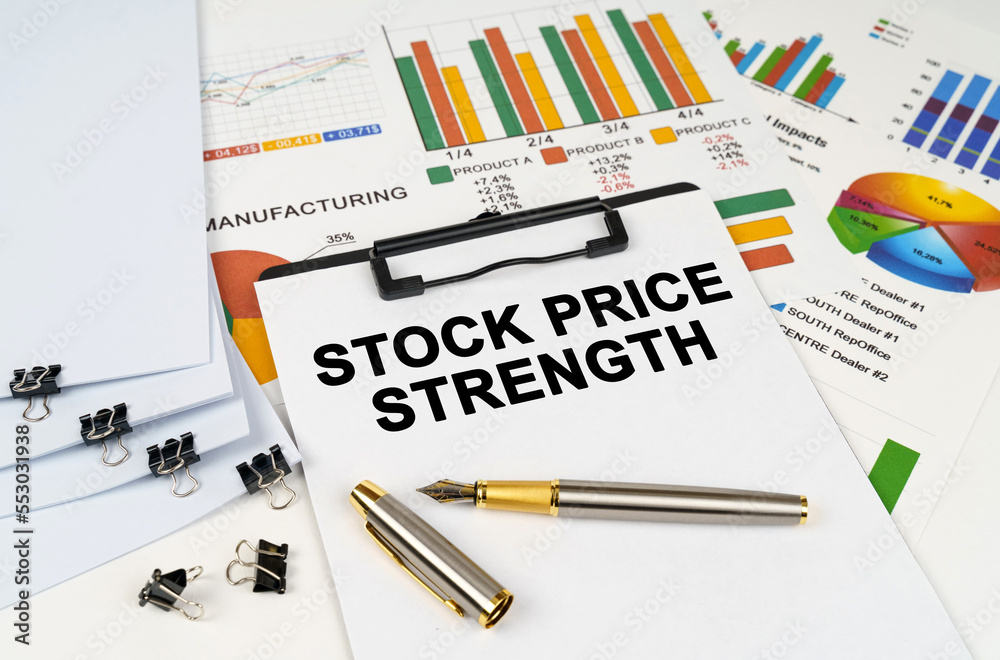On the table among financial graphs and charts lies a tablet with the inscription - STOCK PRICE STRENGTH On the table among financial graphs and charts lies a tablet with the inscription - STOCK PRICE STRENGTH