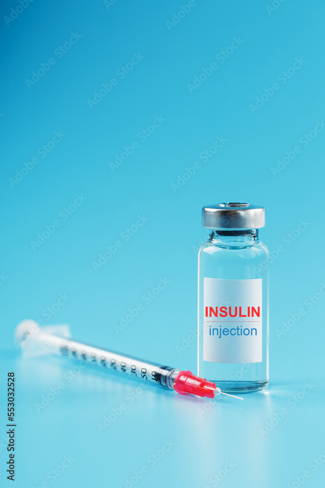 A bottle of insulin hormone and a syringe on the table A bottle of insulin hormone and a syringe on the table