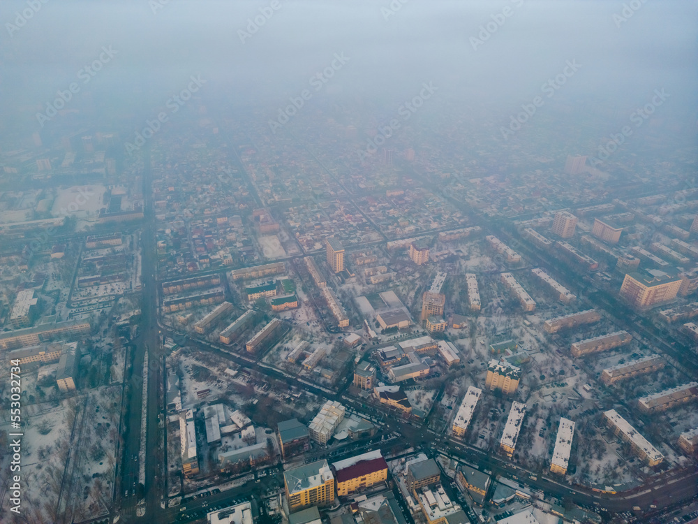 Aerial view of polluted city covered with smog