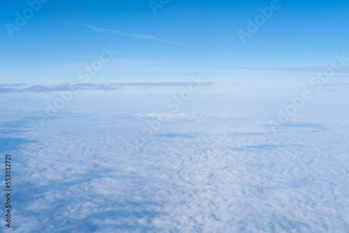 Background of a pink purple heavenly sky with fluffy dense clouds, top view from an airplane. Sky Gradient.