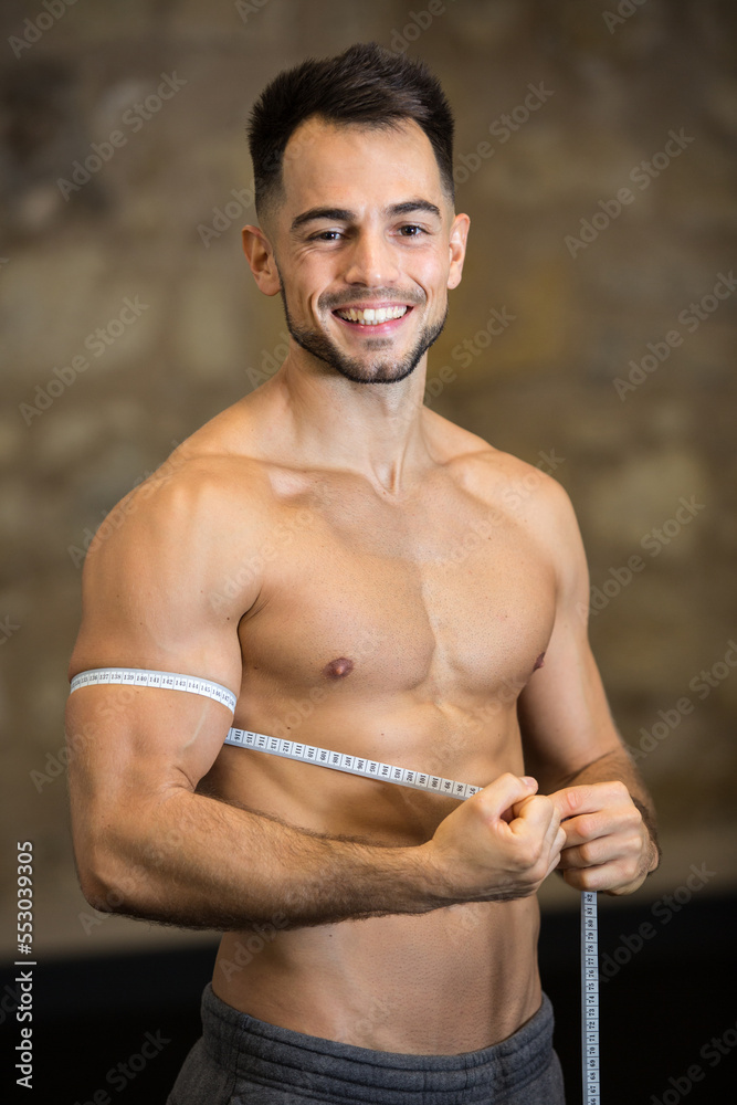man measuring biceps with measuring tape man measuring biceps with measuring tape