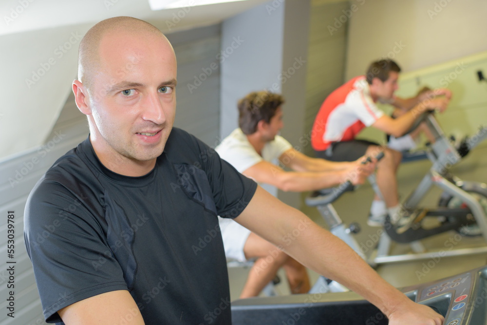 a man cycling in gym a man cycling in gym