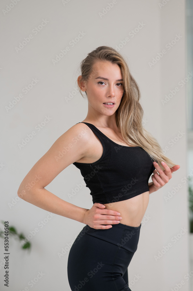 Portrait of a beautiful caucasian woman in black sportswear. Portrait of a beautiful caucasian woman in black sportswear.