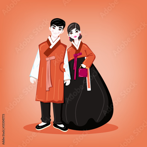 Korean young couple dressed in orange hanbok. Dark-haired people in orange national Korean costume against an orange background. 