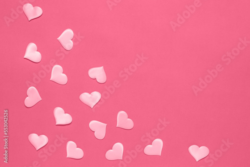 Pink silk hearts on a background of color viva magenta. Valentine's Day. Trendy color of the year 2023-Viva Magenta.