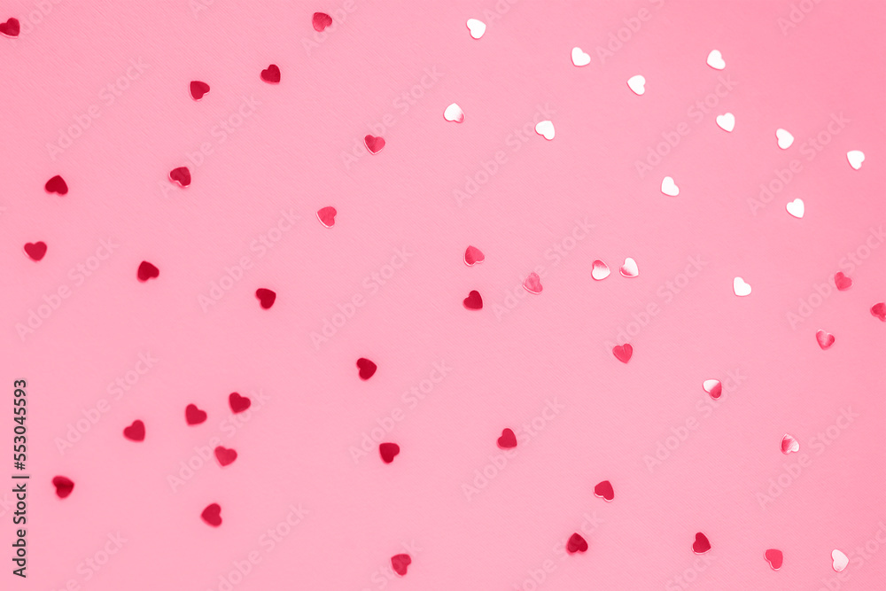 Pink festive background with confetti, texture. Selective focus
