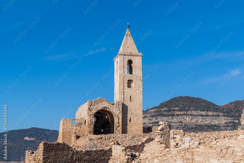Historic church of the Sau swamp. Sau bell tower is completely uncovered due to the lack of water in the swamp. Tourism in Osona, Barcelona, Catalonia, Spain.