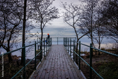 Wooden pier over the lake. Calm and peaceful view at sunset. Lough Neagh, Northern Ireland, UK photo