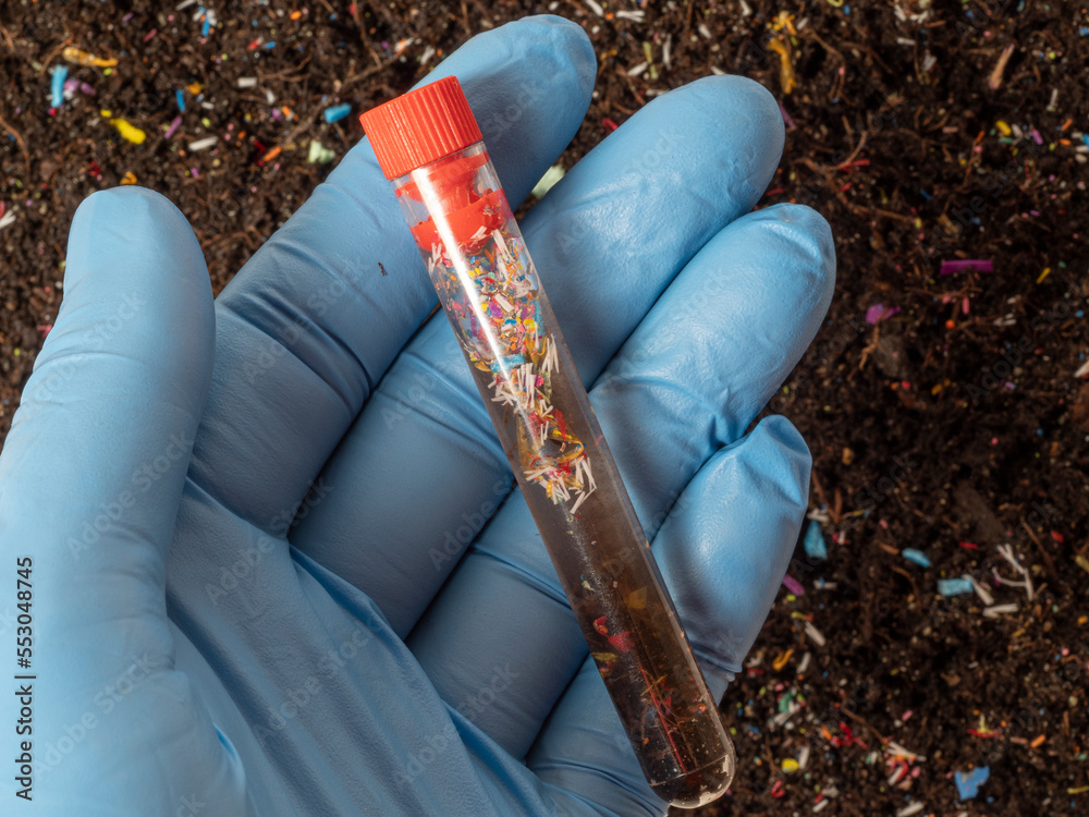 Microplastics in soil a test tube with soil sample soil contaminated