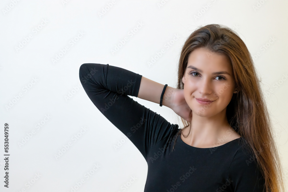 Smiling attractive girl is posing on the light background. Horizontally. Smiling attractive girl is posing on the light background. Horizontally.