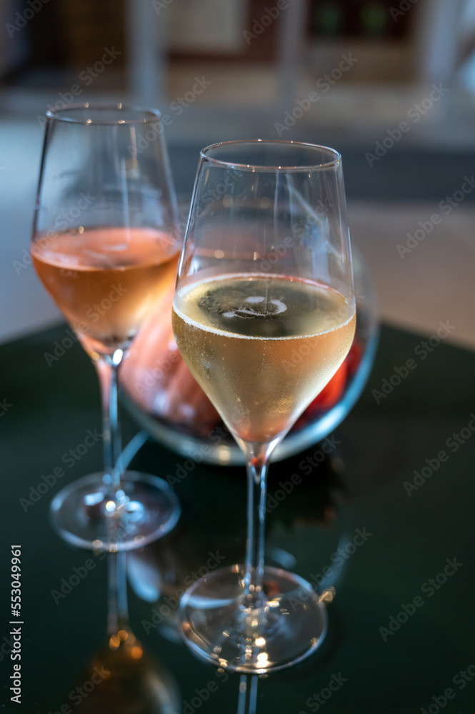 Tasting of brut and rose champagne sparkling wine produced by traditional method in underground caves in Champagne, France