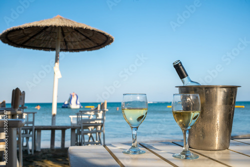 Wallpaper Mural Drinking of cold white wine in beach bar, summer holidays, relax on sandy beach Torontodigital.ca