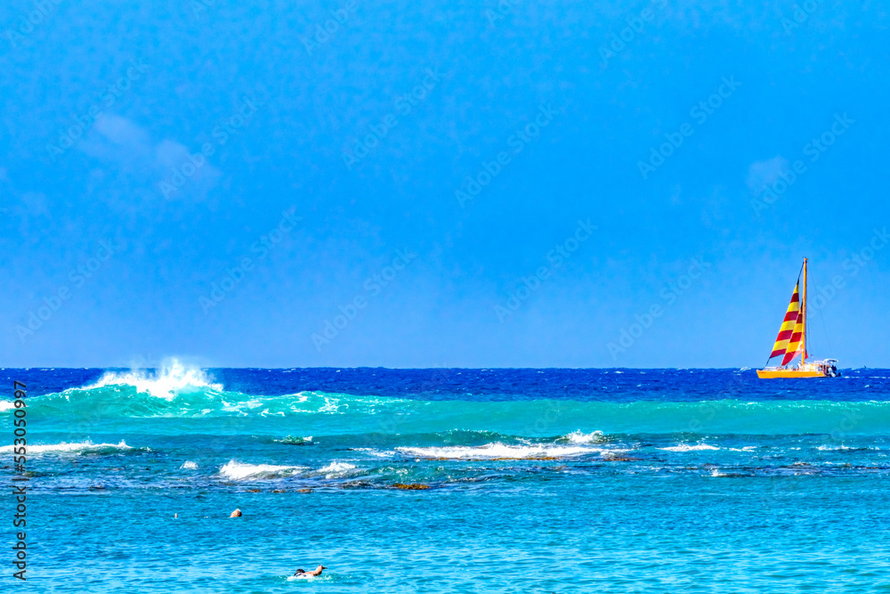 Naklejka premium Colorful Sailboat Swimmers Blue Water Waikiki Beach Honolulu Hawaii