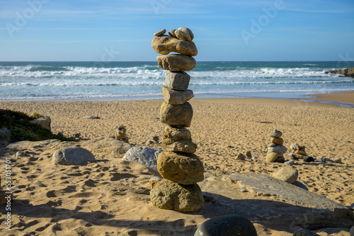 Pyramid from stack balanced stones on sandy beach  Atlantic ocean  Portugal